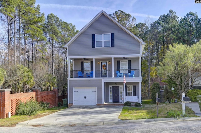 view of front of home featuring a garage, a balcony, and ceiling fan