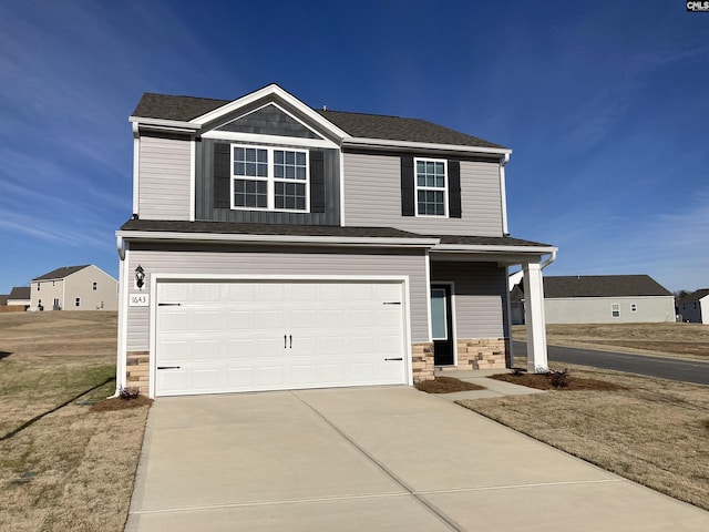 view of front of property featuring a garage and a front lawn