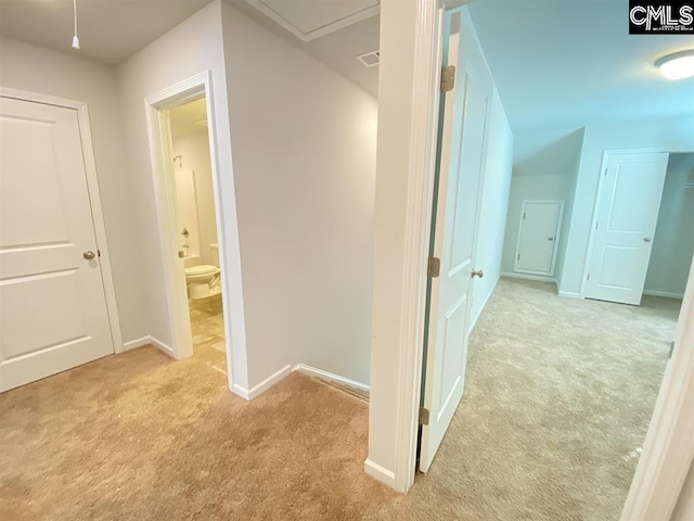 hall with light colored carpet