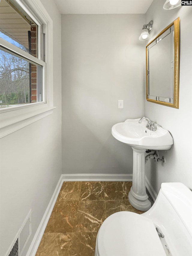 bathroom featuring visible vents, marble finish floor, toilet, and baseboards