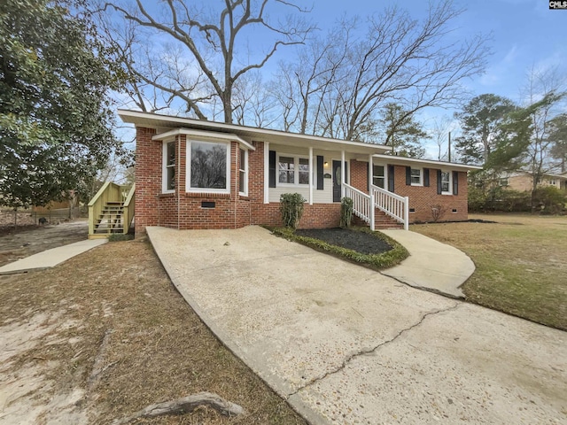 ranch-style home featuring crawl space and brick siding