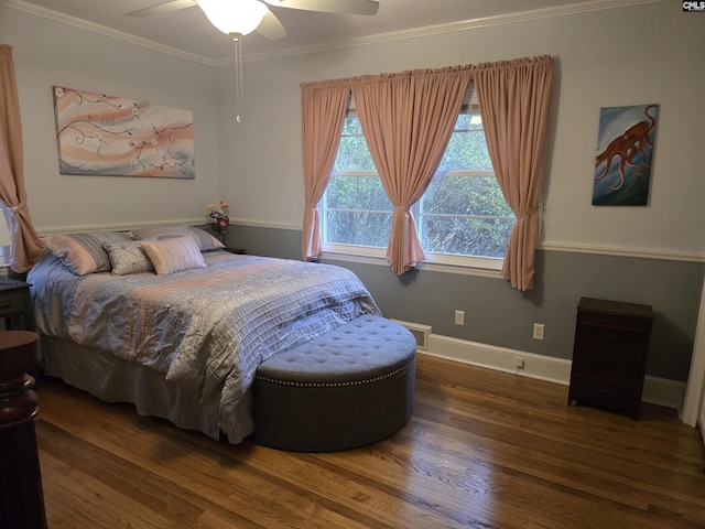 bedroom featuring a ceiling fan, crown molding, baseboards, and wood finished floors