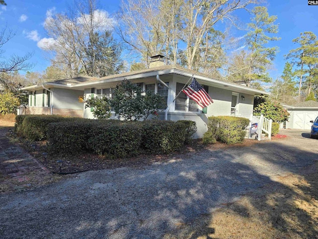 view of front of home featuring a chimney and brick siding