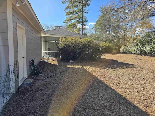 view of yard featuring a sunroom