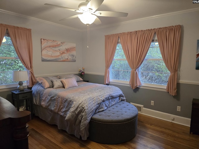 bedroom with visible vents, baseboards, ceiling fan, wood finished floors, and crown molding