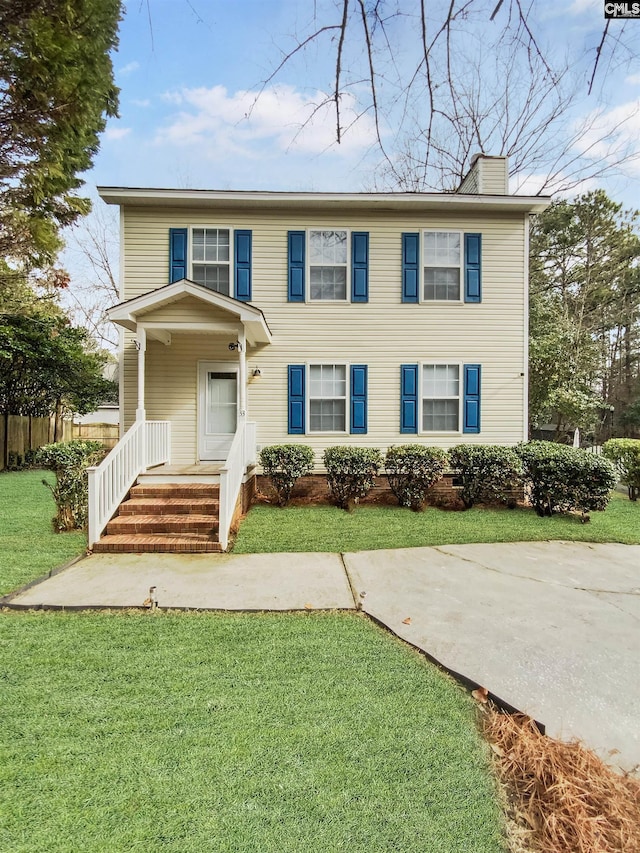 colonial inspired home with a front yard