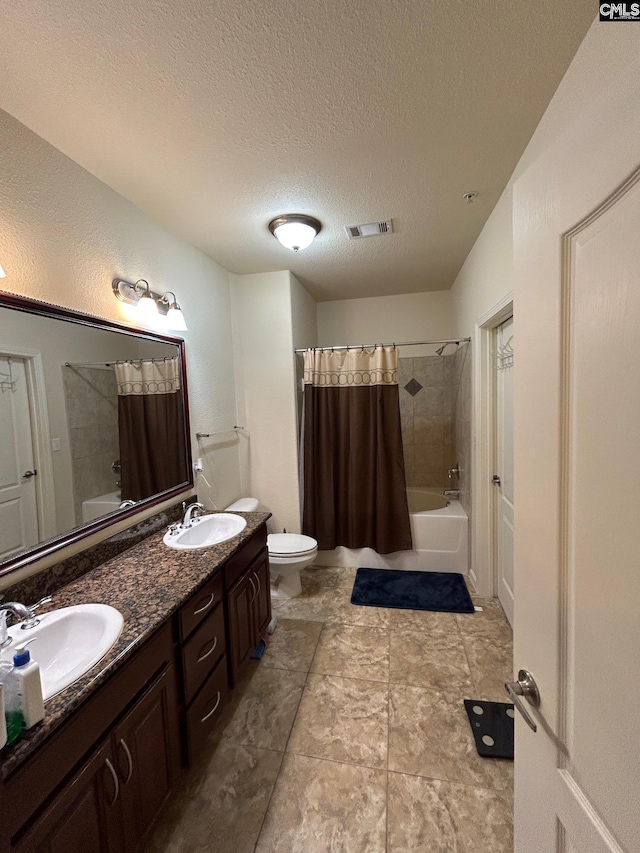 full bathroom with vanity, toilet, shower / bath combination with curtain, and a textured ceiling