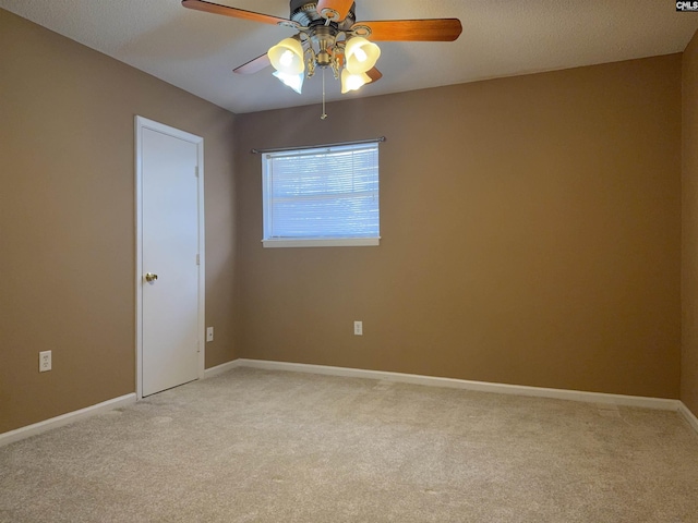 spare room featuring light carpet and ceiling fan