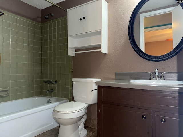 full bathroom featuring vanity, toilet, tiled shower / bath combo, and tile patterned flooring