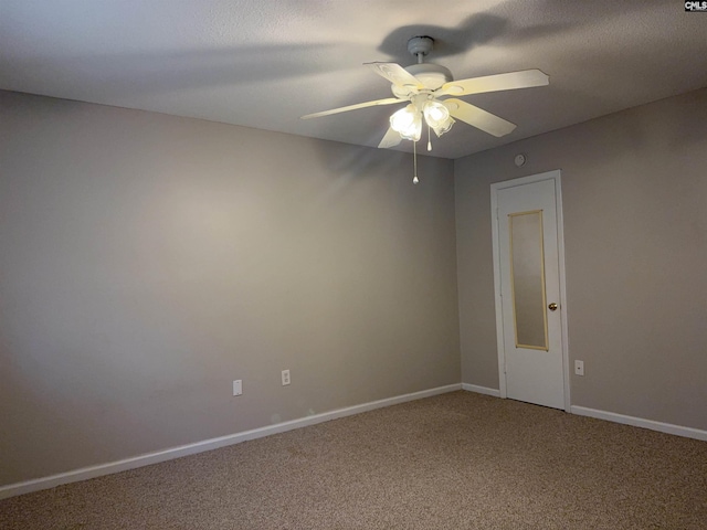 carpeted spare room with ceiling fan and a textured ceiling