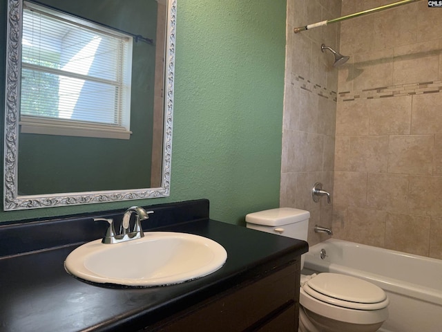 full bathroom with tiled shower / bath combo, vanity, and toilet