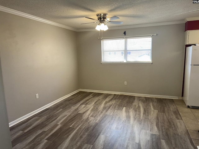 unfurnished room featuring a textured ceiling, dark wood-type flooring, ornamental molding, and ceiling fan