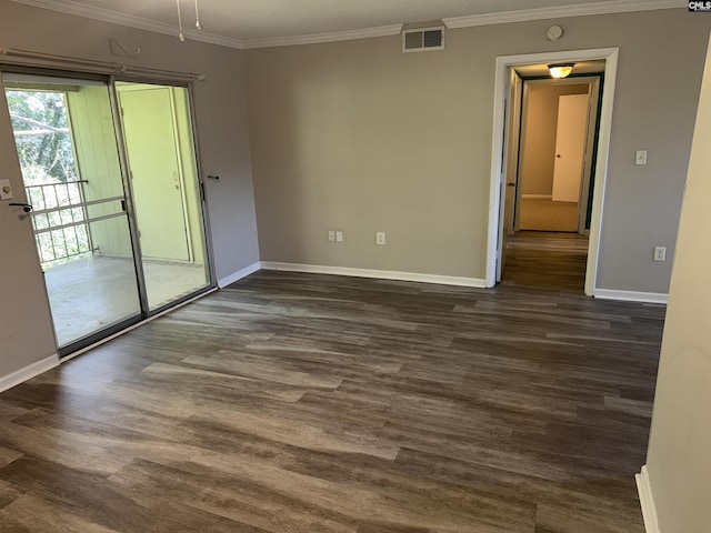 spare room with crown molding and dark wood-type flooring