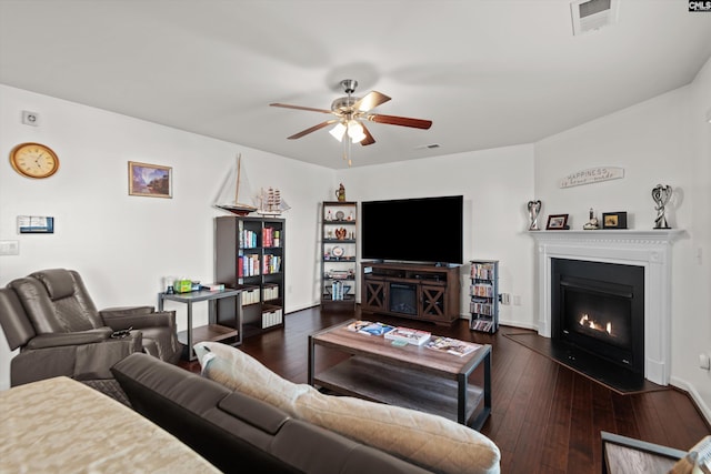 living room featuring ceiling fan and dark hardwood / wood-style flooring