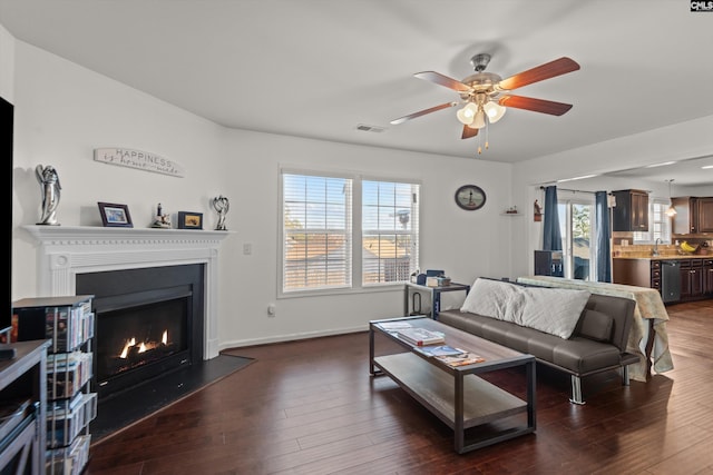 living room with sink, dark hardwood / wood-style floors, and ceiling fan