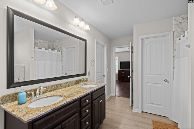 bathroom with vanity, hardwood / wood-style floors, and walk in shower