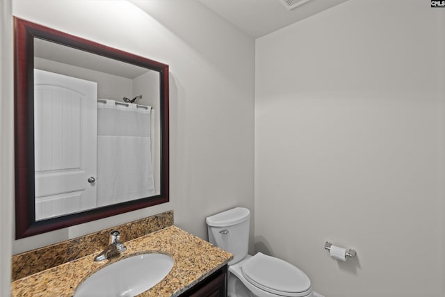 bathroom featuring vanity, a shower with curtain, and toilet