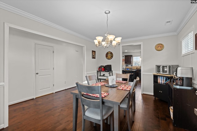 dining room featuring crown molding, an inviting chandelier, and dark hardwood / wood-style flooring