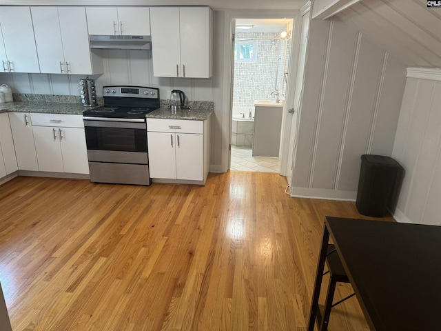 3442 Blossom St, Columbia, SC 29205 - kitchen featuring white cabinetry, light stone counters, and stainless steel electric stove