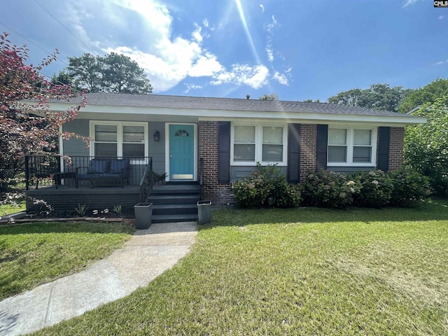 ranch-style home with a porch and a front lawn