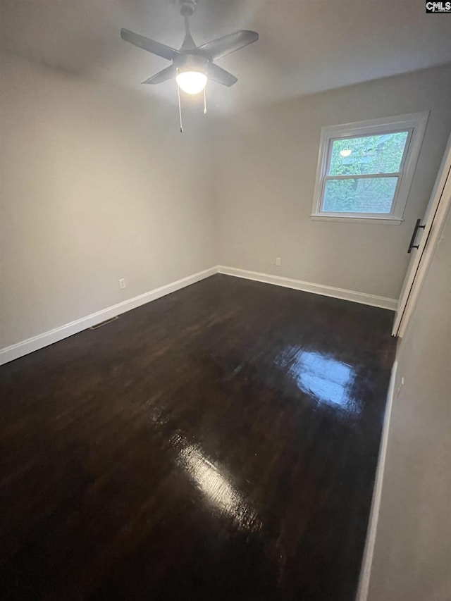 unfurnished room with dark hardwood / wood-style floors and ceiling fan