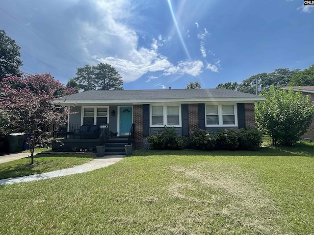 ranch-style house featuring a front yard and covered porch