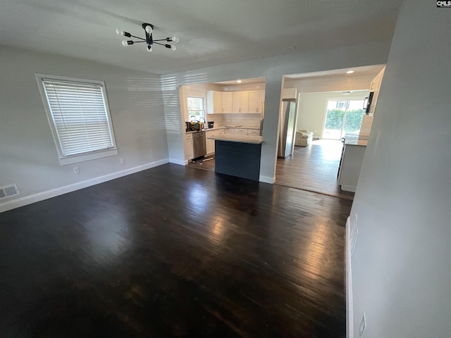 kitchen featuring backsplash, stainless steel appliances, dark hardwood / wood-style floors, and white cabinets