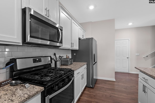 kitchen with appliances with stainless steel finishes and white cabinets