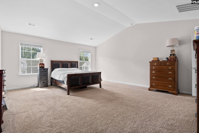 carpeted bedroom featuring lofted ceiling