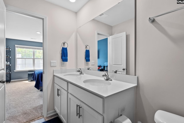 bathroom featuring toilet and vanity