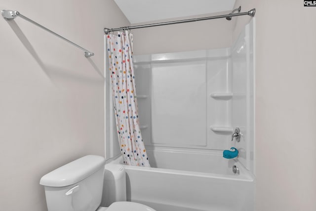 bathroom featuring shower / bath combination with curtain and toilet