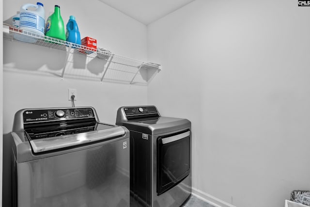 clothes washing area featuring washer and dryer