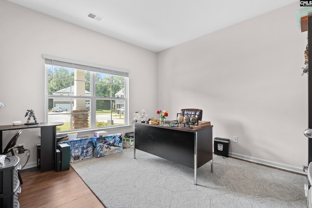 home office with hardwood / wood-style flooring