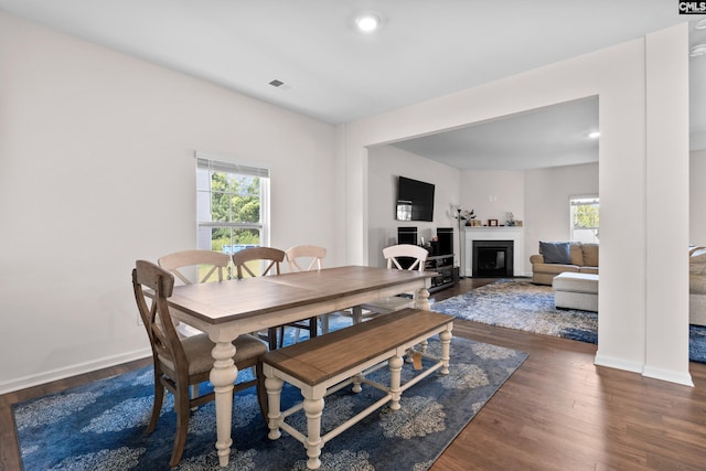 dining space with dark hardwood / wood-style flooring