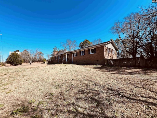 view of side of property with a lawn