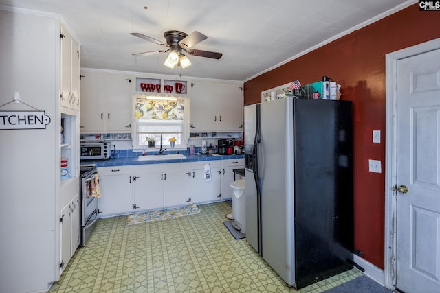 kitchen with white cabinetry, appliances with stainless steel finishes, sink, and crown molding