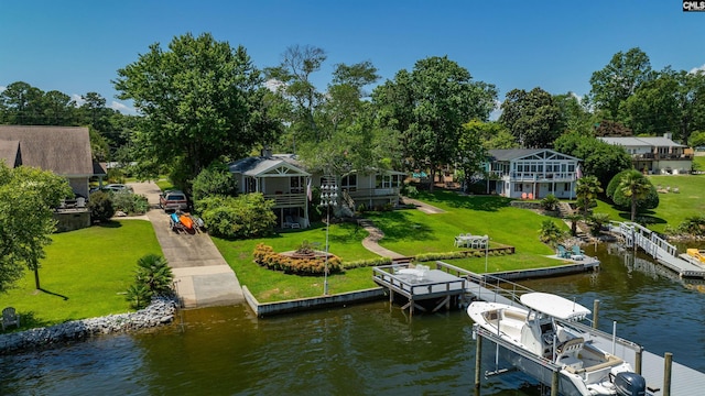 dock area featuring a water view and a lawn