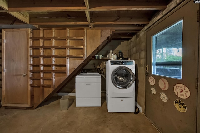 clothes washing area featuring independent washer and dryer