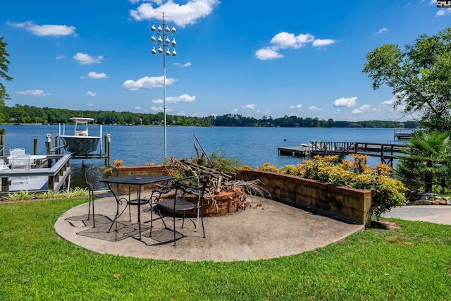 view of patio with a water view and a dock