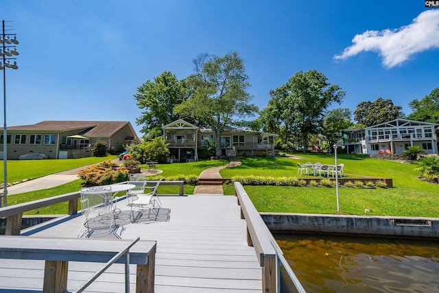 dock area featuring a yard and a water view