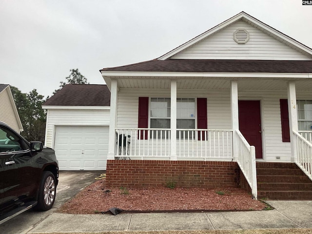 view of front of house featuring a porch and a garage