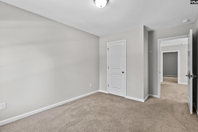 unfurnished bedroom with light colored carpet