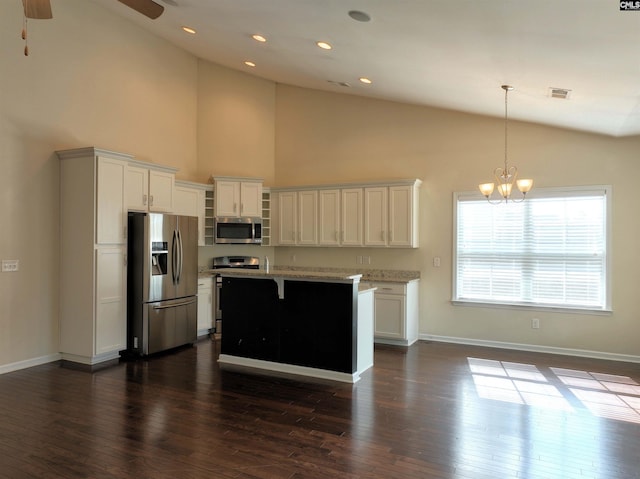 kitchen with white cabinetry, pendant lighting, stainless steel appliances, and a kitchen island