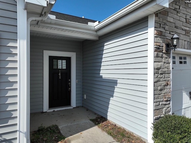 view of exterior entry with a garage