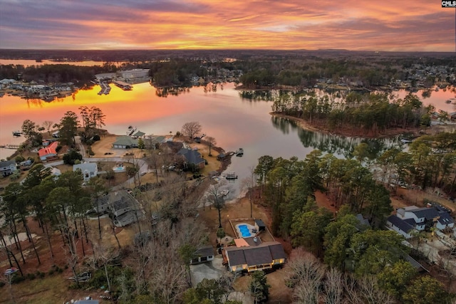 aerial view at dusk with a water view