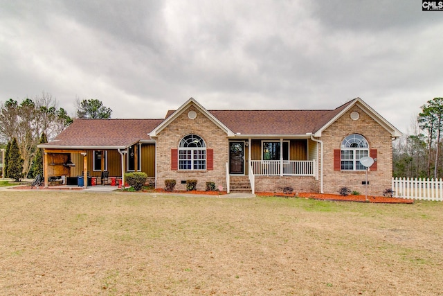 ranch-style home with covered porch and a front yard