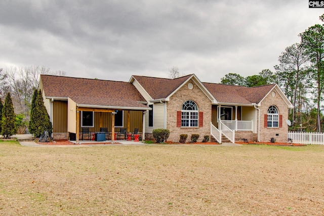 ranch-style house with covered porch and a front lawn