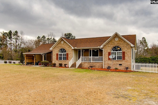 single story home featuring covered porch and a front yard