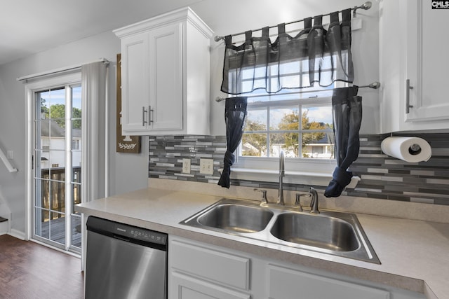 kitchen featuring sink, backsplash, dishwasher, dark wood-type flooring, and white cabinets