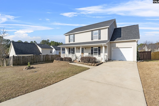 view of front of property featuring a garage, a front lawn, and a porch